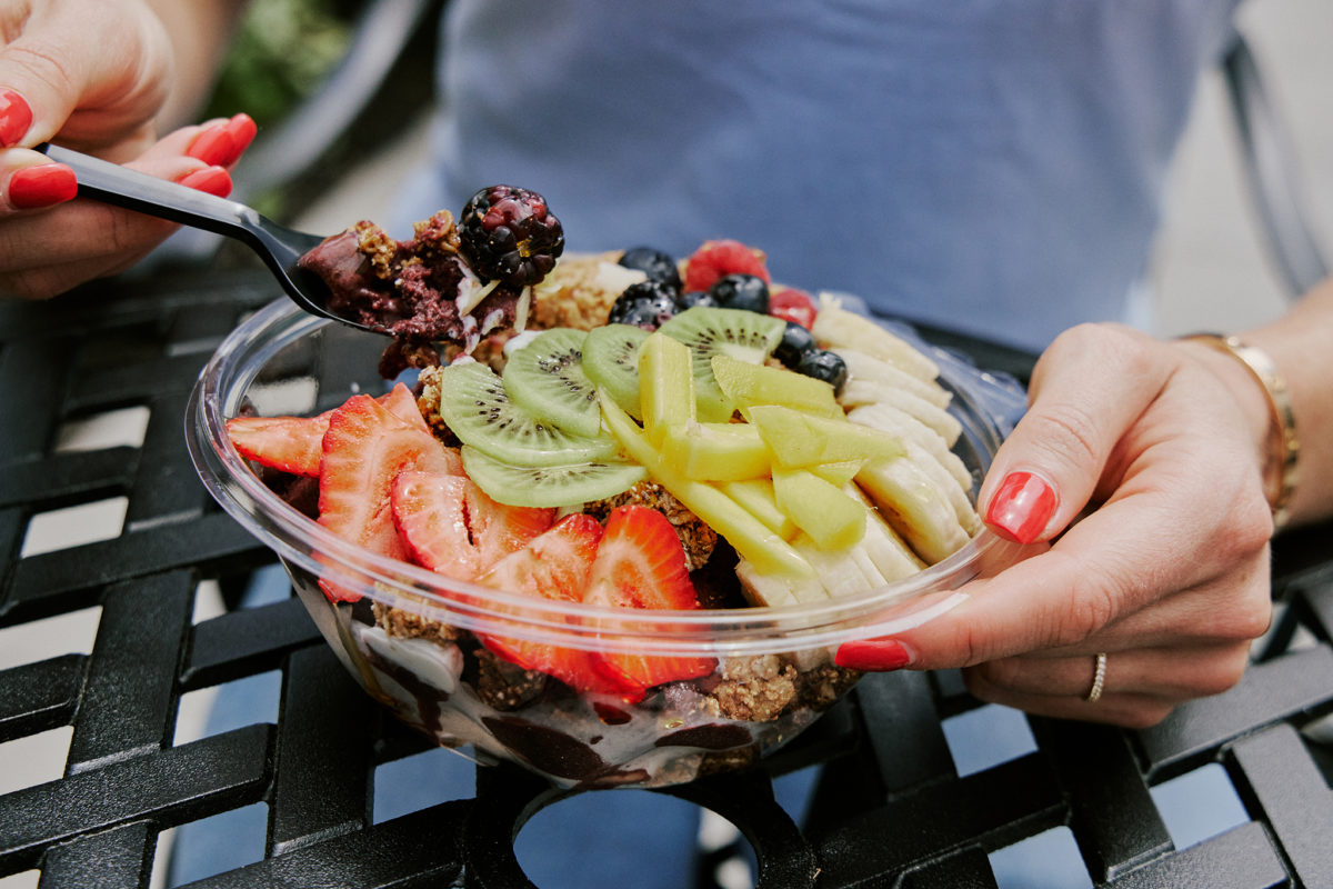 person eating salad from Namaste Cafe one of the best Restaurants and Takeout Options in Duxbury